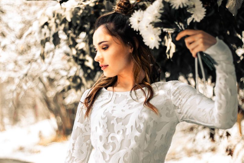 Bride holding a bouquet of flowers over her head